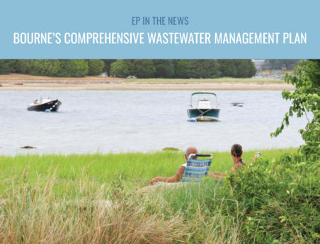 Two people sit in chairs facing a body of water